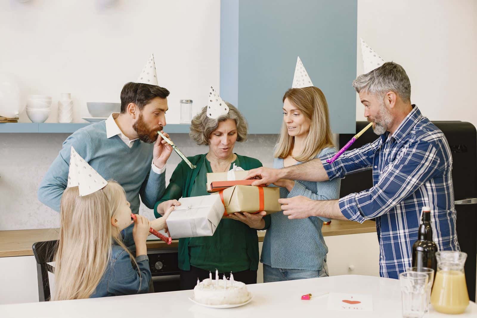Family exchanging gifts during an indoor celebration