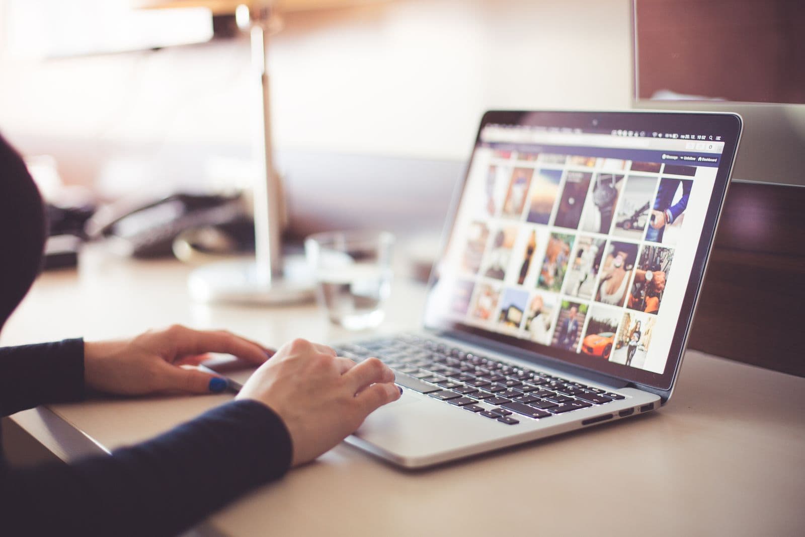 Person browsing a photo gallery on a laptop