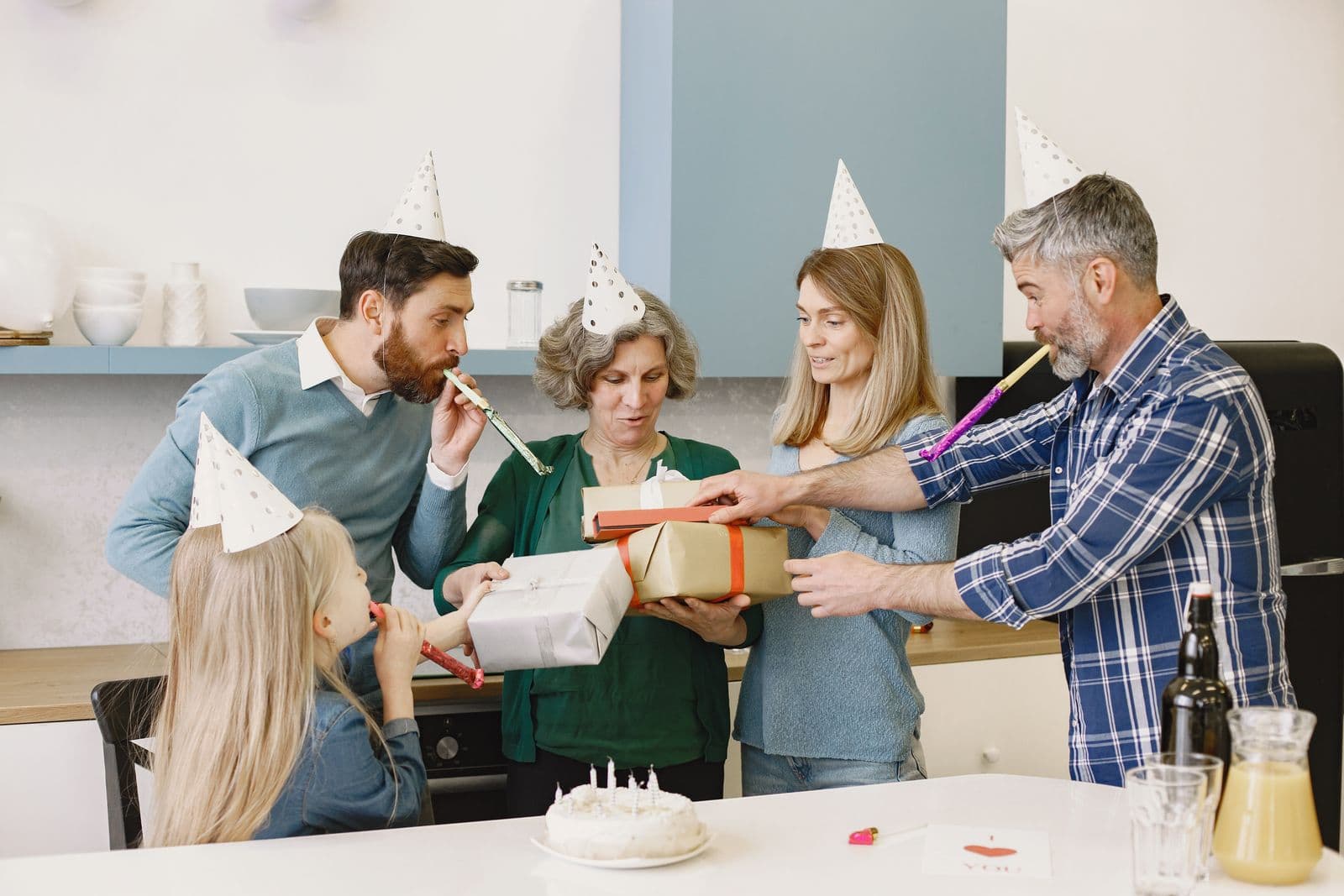 Family exchanging gifts during an indoor celebration