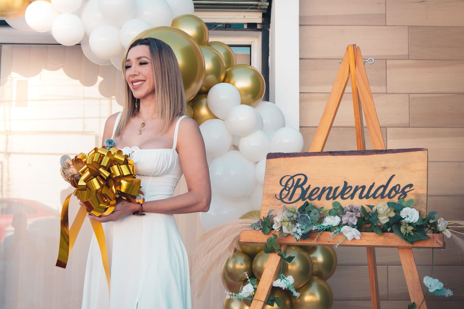 Guest standing beside an event welcome sign