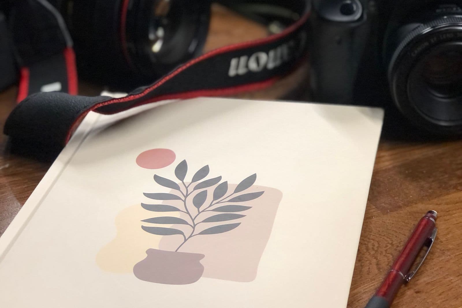 Camera and notebook ready for an event photography brief