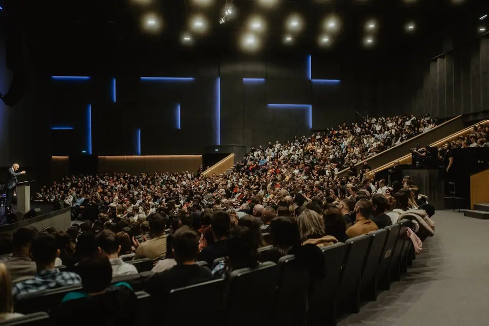 Audience filling a modern conference auditorium