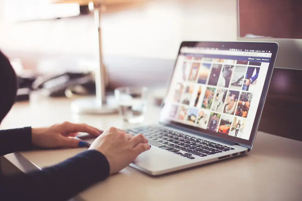 Person browsing a photo gallery on a laptop