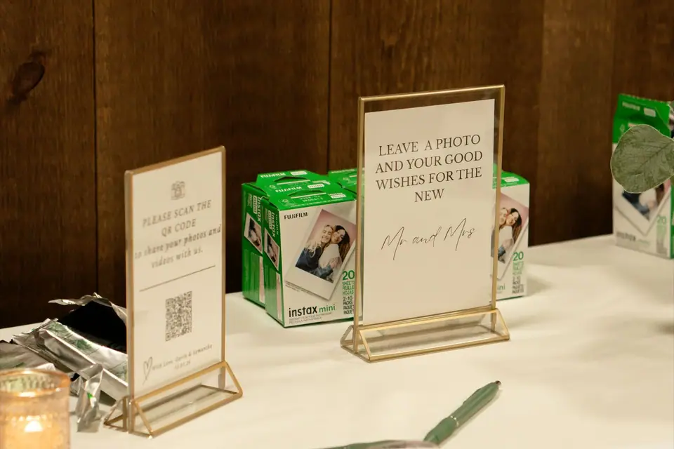 Wedding guest table with a Polaroid camera and an open guest book