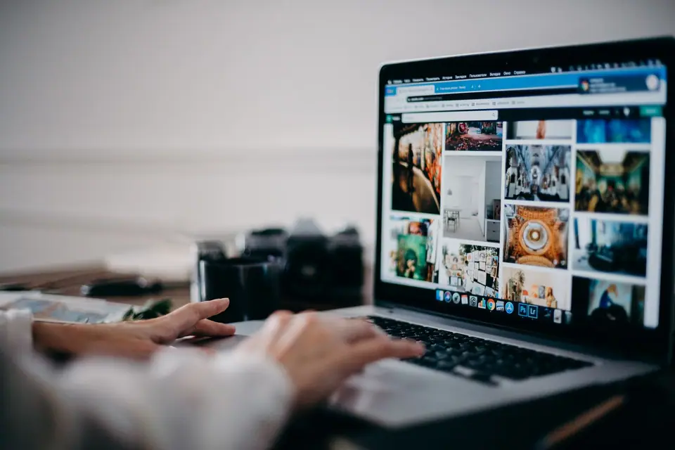Person browsing a digital photo gallery on a laptop