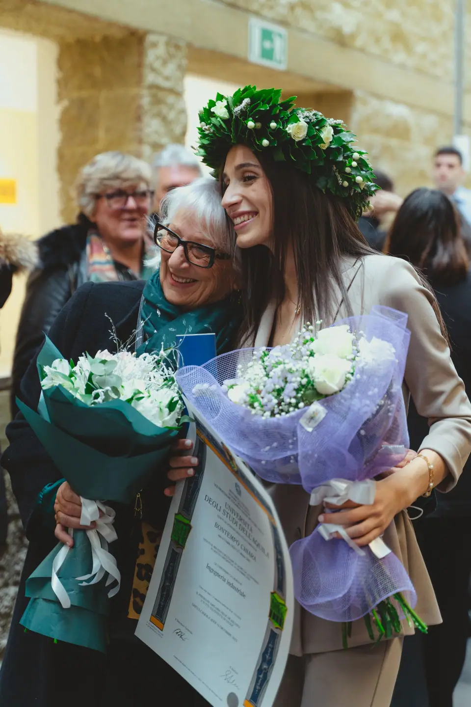 Graduate celebrating with family after a ceremony